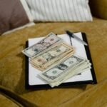 Close-up of US dollar banknotes on a sofa, symbolizing finance and wealth.